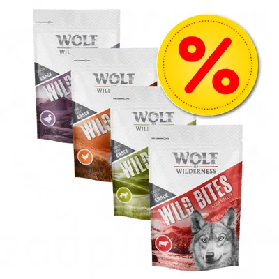 Lot de 4 sachets Wolf of Wilderness Wild Bites, différentes variétés visibles, logo pourcentage jaune indiquant une offre ou promotion.