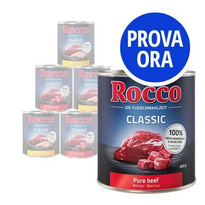 Rocco Classic Pure beef, lattina da 800 g con etichetta '100% fresh ingredients & grain-free'. Cerchio blu con testo: PROVA ORA. Altre varianti Rocco Classic visibili sullo sfondo.
