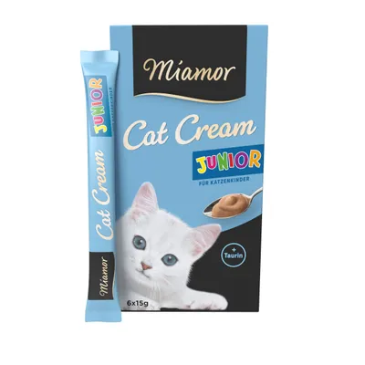 Miamor Cat Cream Junior, boîte bleue avec chaton blanc, texte visible : JUNIOR für Katzenkinder, + Taurin, 6x15g. Stick individuel et cuillère de crème illustrés.
