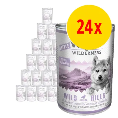 24x Wolf of Wilderness Little Wild Hills Junior våtfoder, 400 g burkar. Text: 100% grain-free. Bild på staplade burkar och en stor burk med bergsmotiv.