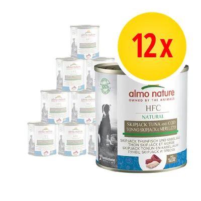 12 lattine Almo Nature HFC Natural tonno skipjack e merluzzo, ricetta senza glutine, immagine di cane sulla confezione, testo multilingue visibile sull'etichetta.