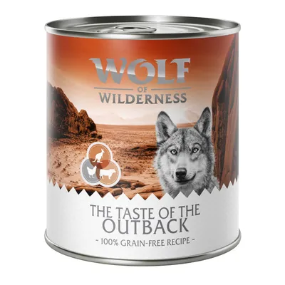Wolf of Wilderness dåse med tekst: THE TASTE OF THE OUTBACK, 100% grain-free recipe. Illustration af dyr og ørkenlandskab på emballagen.