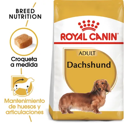Saco de pienso Royal Canin Adult Dachshund. Texto visible: 'Croqueta a medida', 'Mantenimiento de huesos y articulaciones', imagen de croqueta y silueta de perro salchicha. Saco de pienso Royal Canin Adult Dachshund. Texto visible: 'Croqueta a medida', 'Mantenimiento de huesos y articulaciones', imagen de croqueta y silueta de perro salchicha.