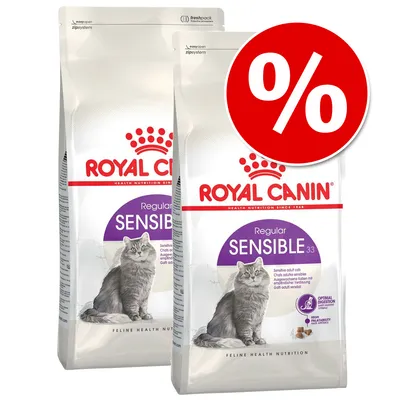 Two bags of Royal Canin Regular Sensible 33 Feline Health Nutrition cat food with a large red percent discount symbol on the top right. Visible text: Optimal Digestion, High Palatability.