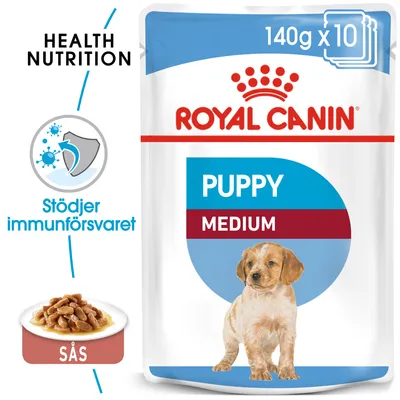 Royal Canin Puppy Medium 140g x10, bild på valp, text: Health Nutrition, Stödjer immunförsvaret, sås. Förpackning med våtfoder för valpar av mellanstora raser.