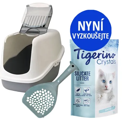 Krytý kočičí záchod, lopatka a balení Tigerino Crystals Silicate Litter 5 l. Modrý kruh s textem: Nyní vyzkoušejte. Viditelné piktogramy vlastností steliva.