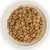 Bowl filled with round, brown dry pet food kibble pieces shown from above.