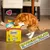 Dreamies Variety Snack Box mit 12 x 60g Packungen. Text: Unwiderstehlich für Katzen und Kätzchen. Roter Kater untersucht die geöffnete Box.