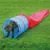 Pet agility tunnel in blue and red shown outdoors on grass, with a pet demonstrating use by walking through the tunnel.