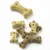 Assorted bone-shaped dog biscuits in light brown and beige colours, various sizes, shown on a white background.