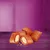 Image shows four filled, crunchy pillow-shaped treats with a creamy centre, displayed on a purple surface. Two treats are broken open to reveal the filling inside.