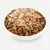 Bowl with brown dry food pieces, topped with shredded, cooked chicken meat.