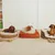 Three dog beds in different designs: woven basket design, orange fabric bed and striped pattern. Dogs are lying on each bed.