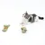 Small kitten lying beside two green fabric toys on a white background, demonstrating use of the pet toy products.