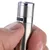 Close-up of a hand holding an adjustable metal handle with a knurled adjustment wheel.