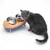 Grey cat next to an orange-blue feeding bowl with two stainless steel dishes, one filled with dry food and the other empty.
