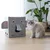 Grey cat cave in elephant shape with ears and trunk, next to a grey cat. Cave made of cardboard with side openings.