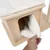 Wooden house with white, soft cover. Hand lifts the cover to show the inside of the house.