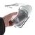 Hand holding transparent container of an electric device with cable and green handle. Device shows on/off button.