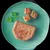 Sliced portion of meat pâté with visible vegetable pieces, served on a plate with parsley garnish. Shows product texture and ingredients.