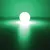 Balle lumineuse ronde émettant une forte lumière blanche avec halo vert visible autour, posée sur une surface sombre. Aucun texte ou marque visible.