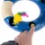 Blue cat toy with yellow plush mouse and colourful tail. Hand presses yellow button, toy includes sisal area and textured surface.