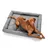 Dog lying on grey dog bed with embroidered Hunter logo.