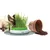 Cat eating from a green Catit cat grass container, next to an overturned flowerpot with soil.