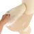 Hand showing removable, beige padded cushion with hook-and-loop fastener on a wooden platform next to a sisal scratching post.