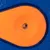 Close-up of an orange and blue toy with a central hole, suitable for interactive play.