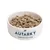 Bowl filled with Autarky complete dog food, showing the product's kibble pieces and the label 'Autarky Complete Dog Food' on the bowl.