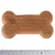 Brown, bone-shaped dog biscuit approximately 10 cm long, shown next to a ruler for size reference.