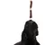 Black dog looks at hanging brown dog snacks, focus on product use.