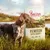 Dog standing beside a bag labelled 'Venison with Rabbit, 80% 20% 0%' outdoors. The bag also shows the brand name Purizon.