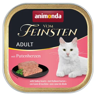 Animonda Vom Feinsten Adult cat food with turkey hearts, serving suggestion on black plate, white cat shown.