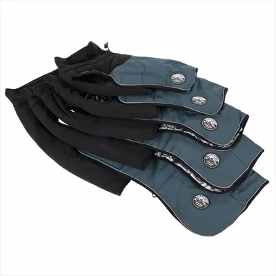 Four blue and black pet coats in different sizes, each with a round badge showing product branding, displayed overlapping to compare size options.