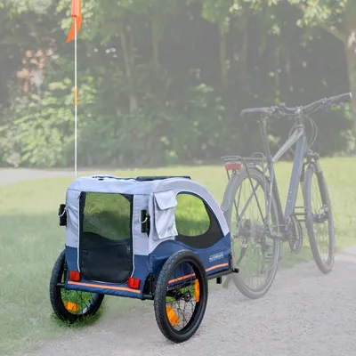 Przyczepka rowerowa dla zwierząt domowych z siatkowymi oknami, niebieska tkanina i flaga bezpieczeństwa. Odpowiednia do rowerów, widoczna na zewnątrz.