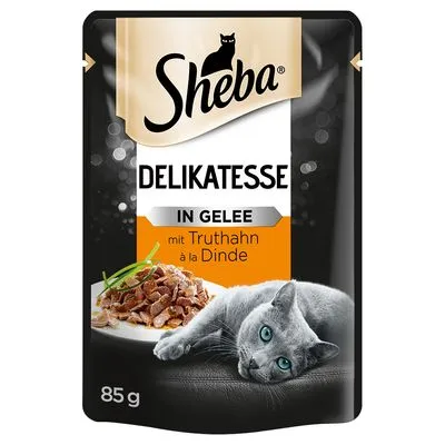Sheba Delikatesse in Gelee mit Truthahn à la Dinde, 85 g. Afbeelding van kattenvoer op een bord en een grijze kat op de verpakking.