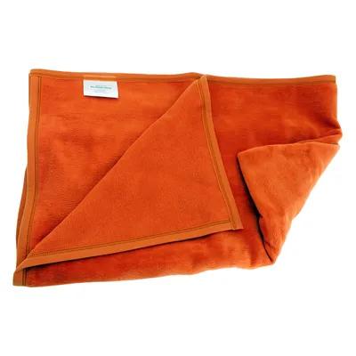 Orange blanket made of soft fabric with visible label. Suitable for pets or household use.
