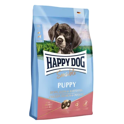 Sac de croquettes Happy Dog Sensible Puppy, Huhn, Lachs & Kartoffel, Chicken, Salmon & Potato, 11 kg, pour chiot. Texte en allemand et anglais visible sur l'emballage.