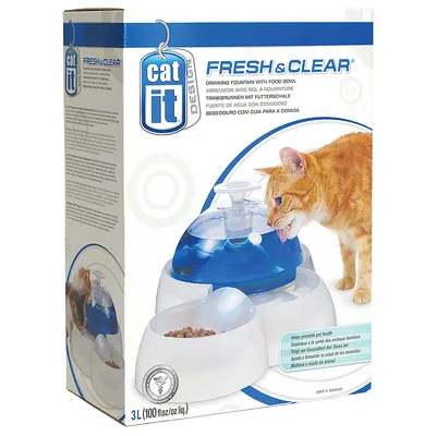 Catit Fresh & Clear fontanella per gatti con ciotola cibo, capacità 3L, immagine di gatto che beve. Testo multilingue e marchio Catit visibili sulla confezione.
