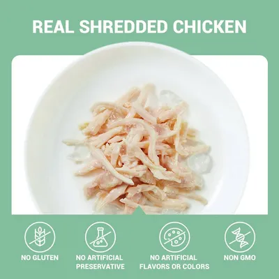 REAL SHREDDED CHICKEN, NO GLUTEN, NO ARTIFICIAL PRESERVATIVE, NO ARTIFICIAL FLAVORS OR COLORS, NON GMO (Engelstalige tekst op afbeelding met kipreepjes in een kom)