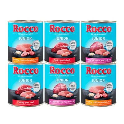 Latas de comida para perros Rocco Junior, variedades visibles: Poultry, chicken hearts & rice; Poultry with beef; Turkey with veal hearts & rice. Texto: Supports healthy growth. 800 g.
