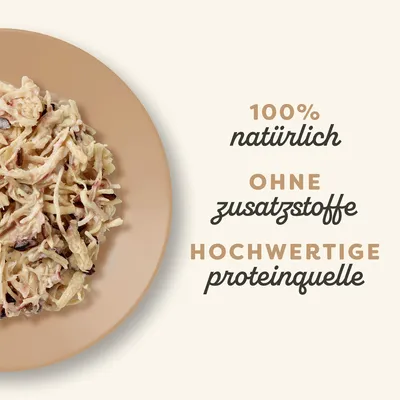 100% natürlich, ohne Zusatzstoffe, hochwertige Proteinquelle. Abgebildet ist zerkleinertes Fleisch auf einem Teller.