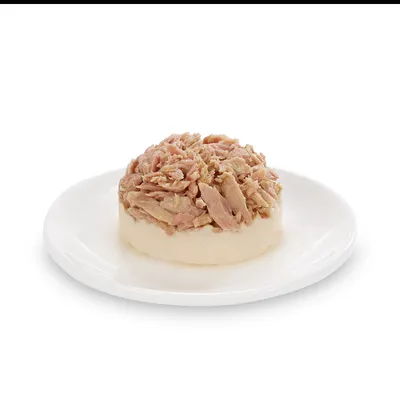 Close-up of chopped meat on a white plate, presented as a product description for pet food.