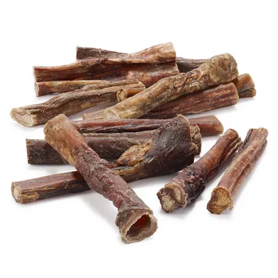 Several dried meat sticks arranged on a white background, showing their natural texture and varying lengths.