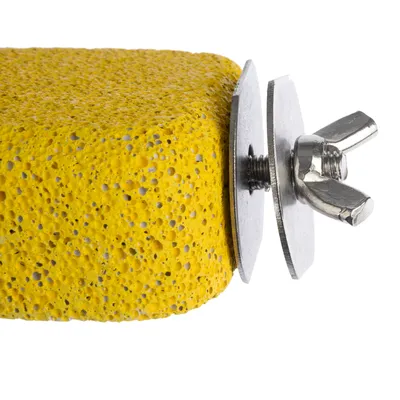 Yellow sharpening stone with metal holder and wing screw, suitable for attachment to cages or enclosures.