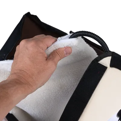 Hand opening zip of a bag with soft white lining and black outer material. A flexible cable is visible inside.
