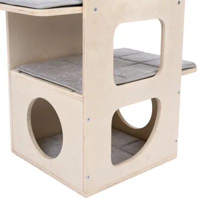 Wooden cat house with two levels, padded resting areas, and round and rectangular openings.