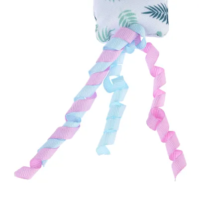 Toy with colourful, spiral-shaped ribbons in pink and blue and a fabric element with leaf pattern.